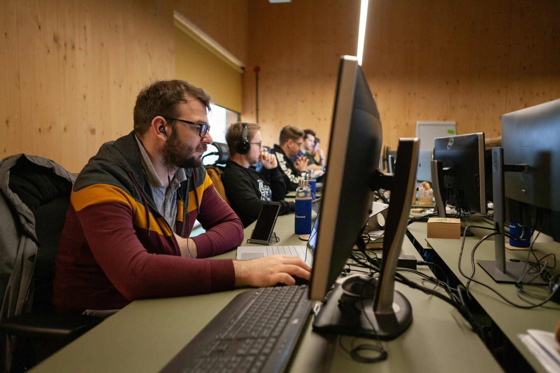 a man sitting in front of a computer on a desk